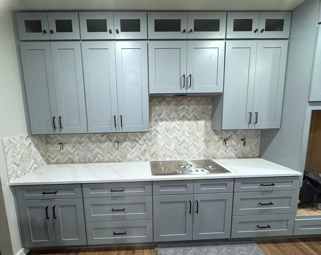 Finished kitchen backsplash with herringbone marble mosaic by Master Floors