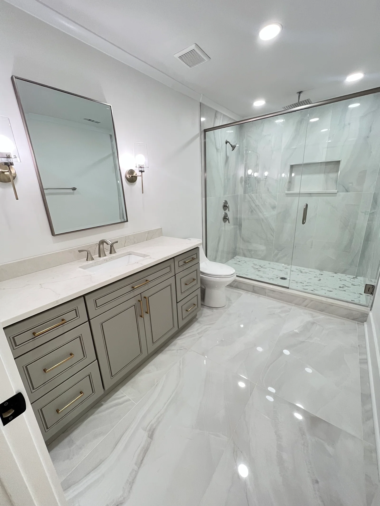 Complete bathroom remodel in Monroe NC with plumbing, walls, flooring, cabinet installation, and painting.